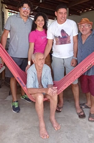 Acima seu Roseno sentado na rede ladeado pelo filho Francisco Brito e netos.